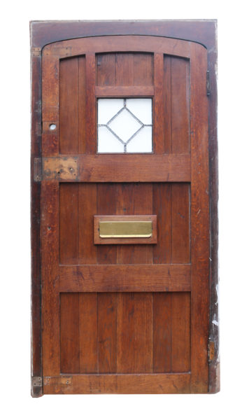 A Reclaimed Arched Oak Exterior Door with Frame