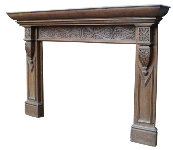 An Antique Jacobean Style Carved Oak Fire Surround