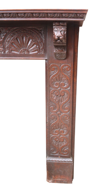 An Antique Jacobean Style Carved Oak Fire Surround