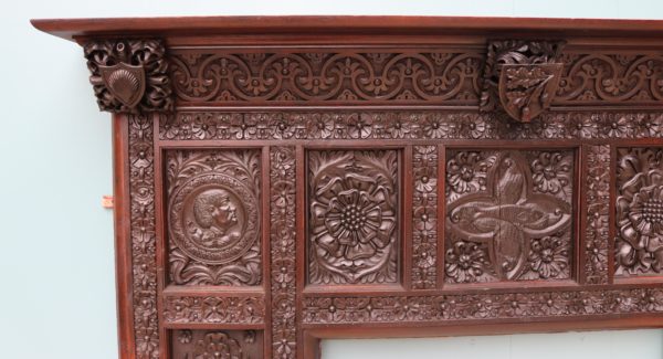An English Jacobean Revival Carved Oak Fireplace