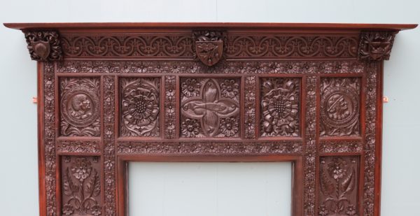 An English Jacobean Revival Carved Oak Fireplace