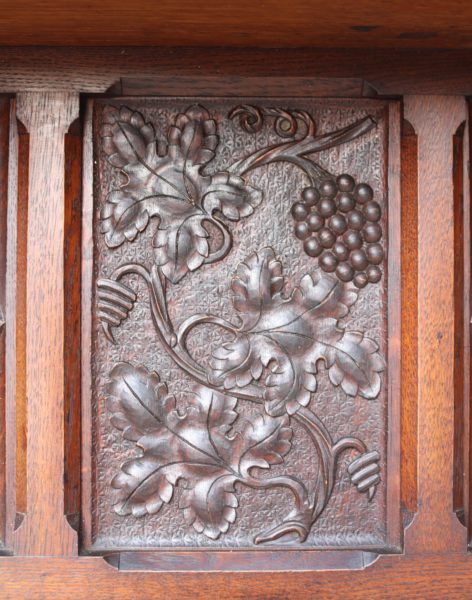 An English Arts and Crafts Style Carved Oak Fireplace