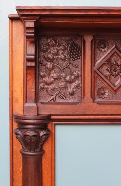 An English Arts and Crafts Style Carved Oak Fireplace