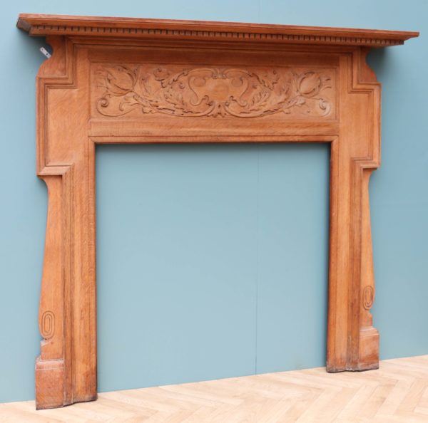 An Antique Art Nouveau Oak Fireplace Surround