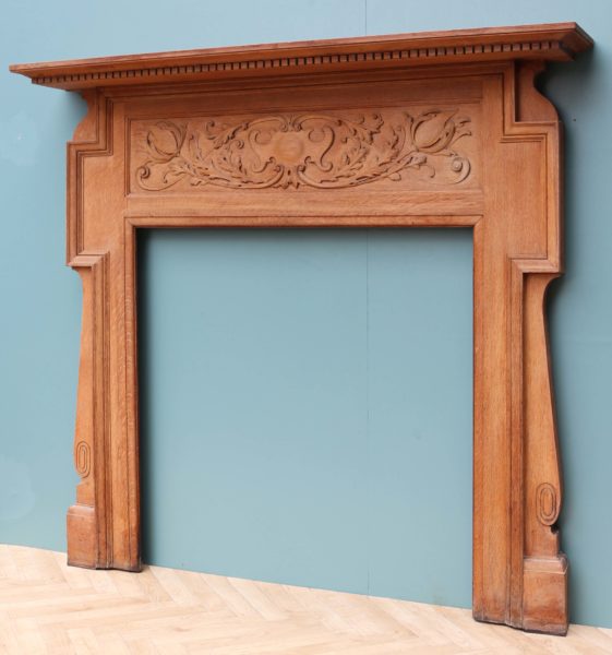 An Antique Art Nouveau Oak Fireplace Surround