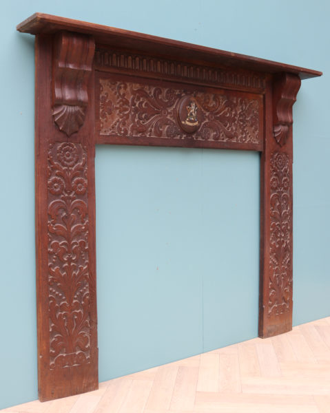 An Antique Jacobean Style Carved Oak Fireplace