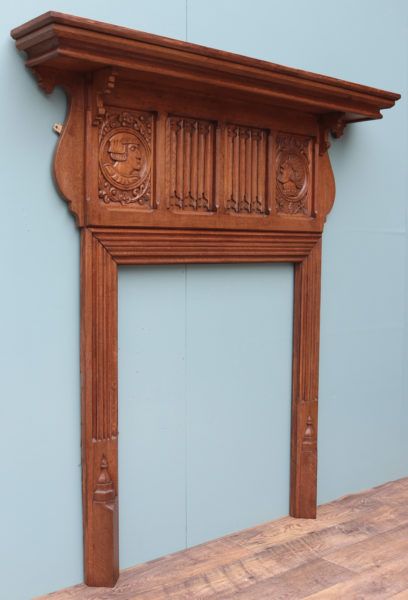 An Antique Jacobean Revival Carved Oak Fireplace