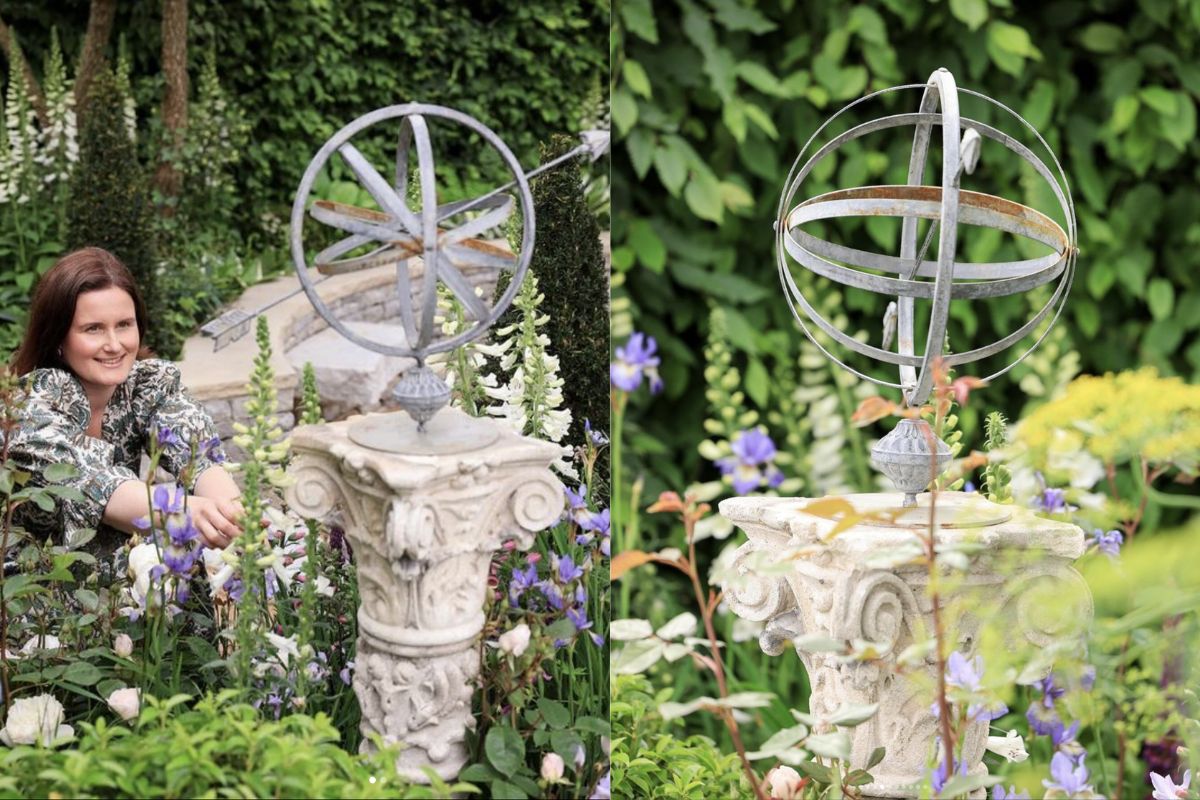 Designer Holly Johnston in The Bridgerton Garden at RHS Chelsea Flower Show, featuring a reclaimed armillary sundial, sourced from UK Architectural Heritage.