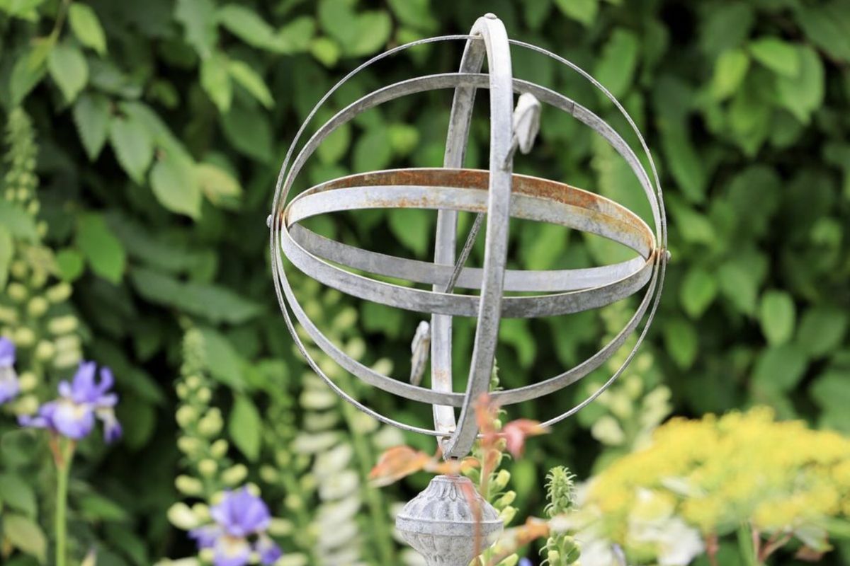 The Bridgerton Garden at RHS Chelsea Flower Show, featuring a reclaimed armillary sundial, sourced from UK Architectural Heritage.