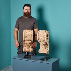 Pair of antique corbels on stand