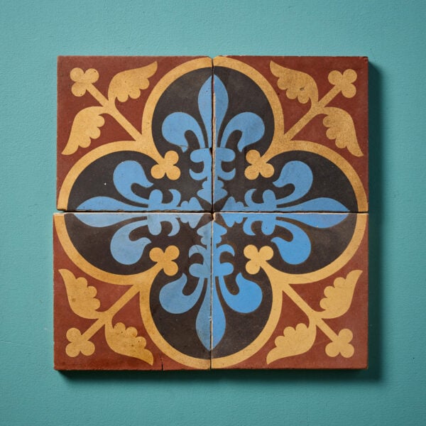 A Set Of Four Reclaimed Encaustic Floral Quatrefoil Tiles